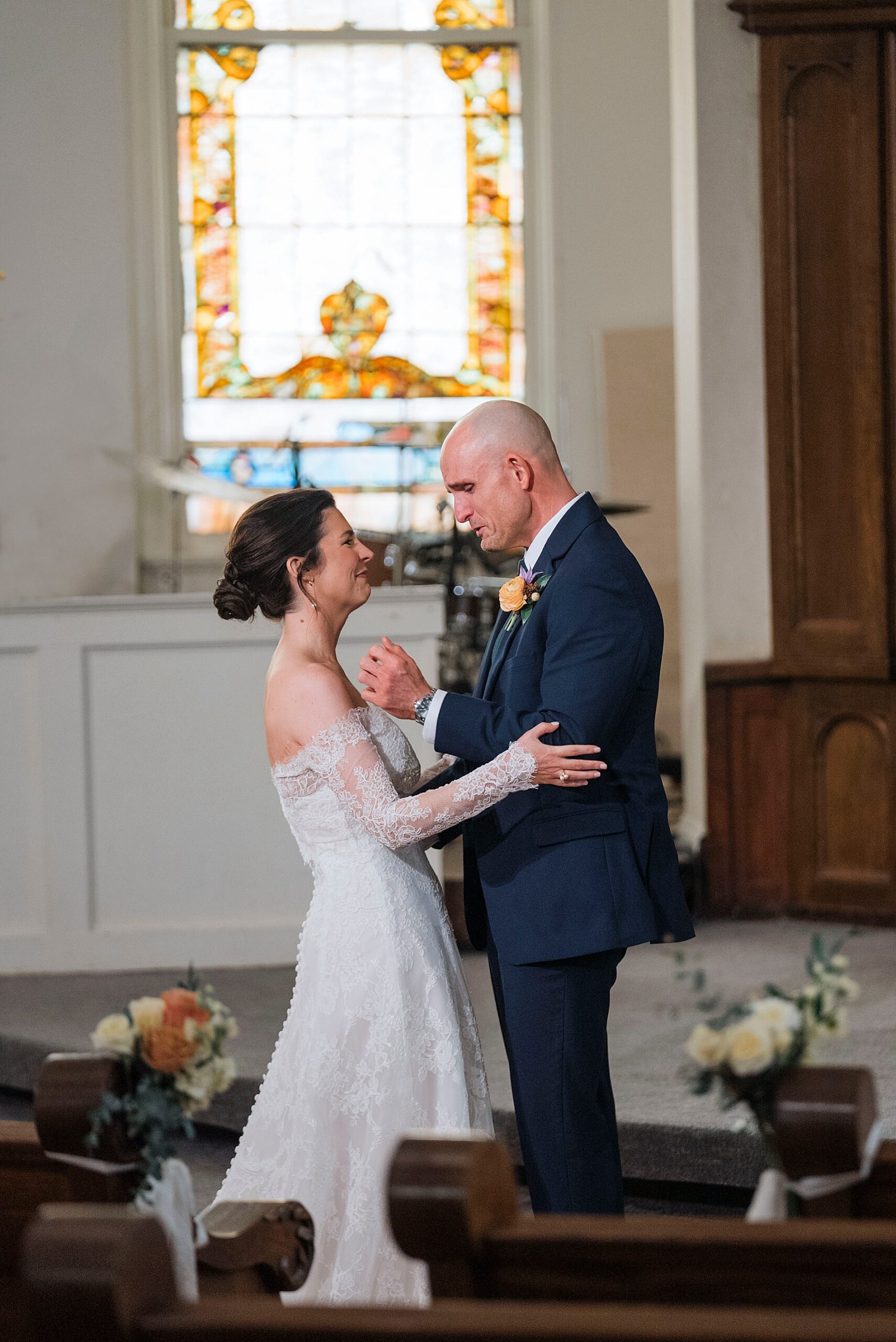 emotional groom during first look with bride inside chapel