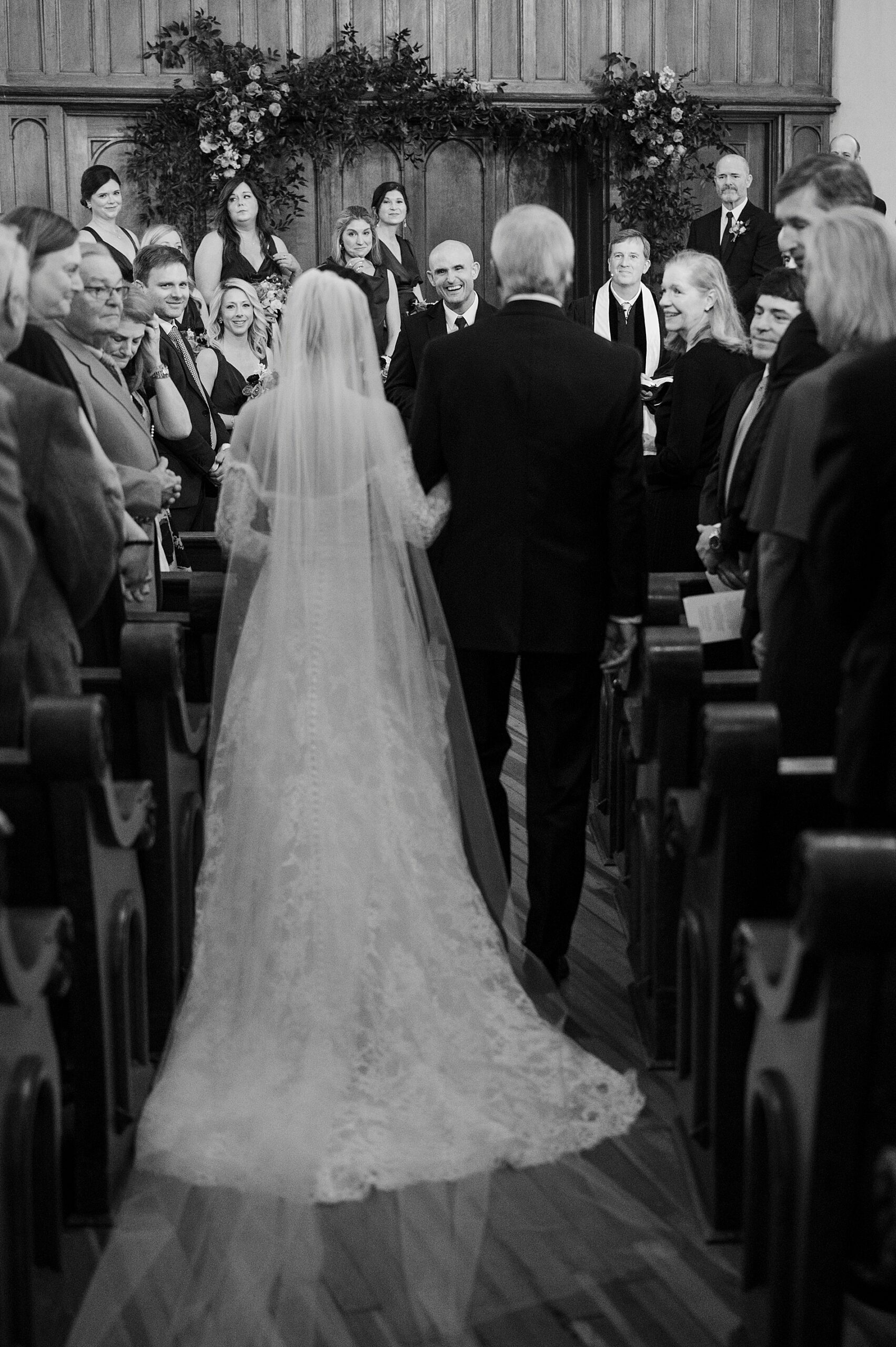 bride walks down aisle to groom at wedding ceremony
