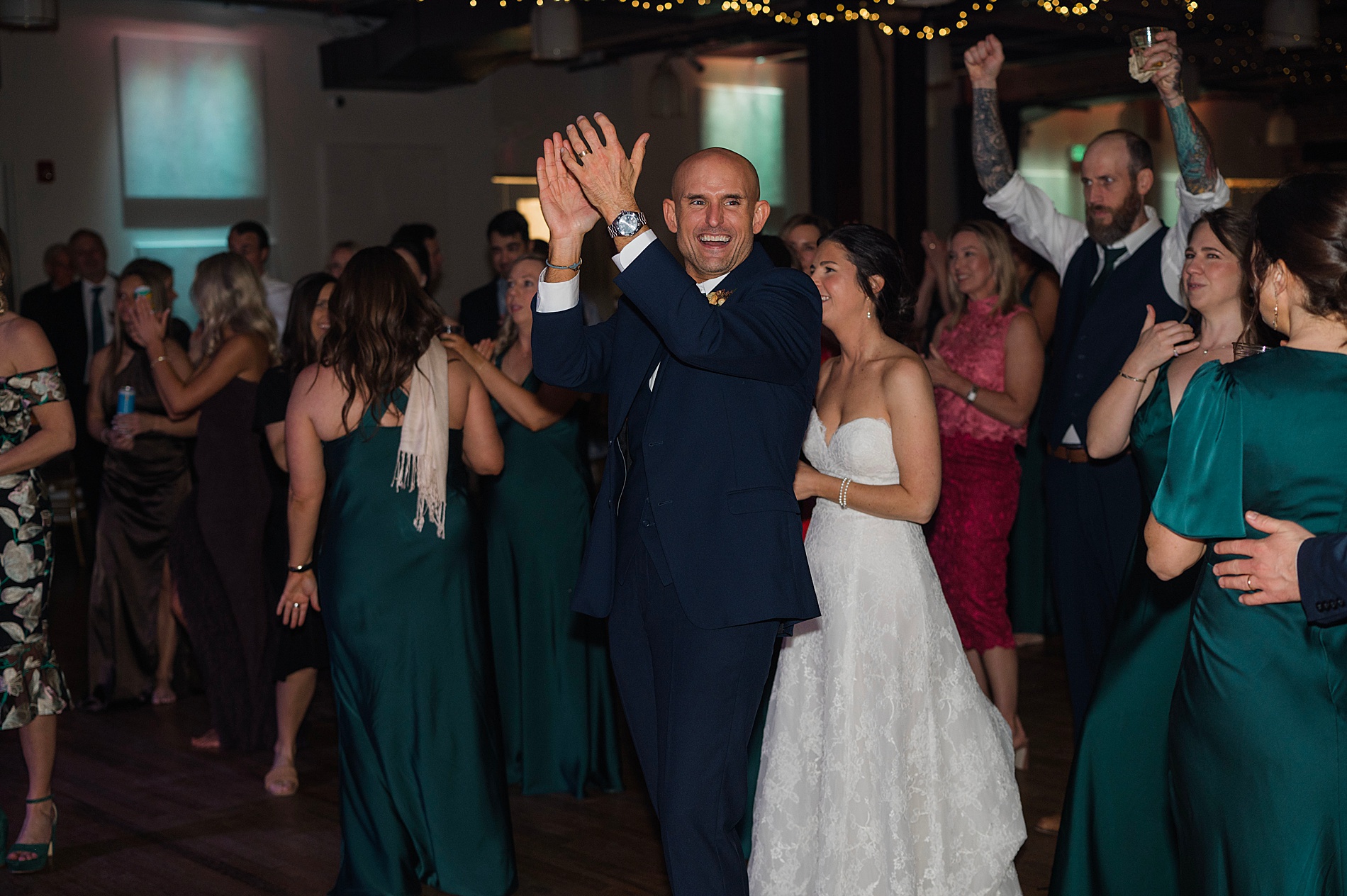 candid portraits of bride and groom on dance floor with guests