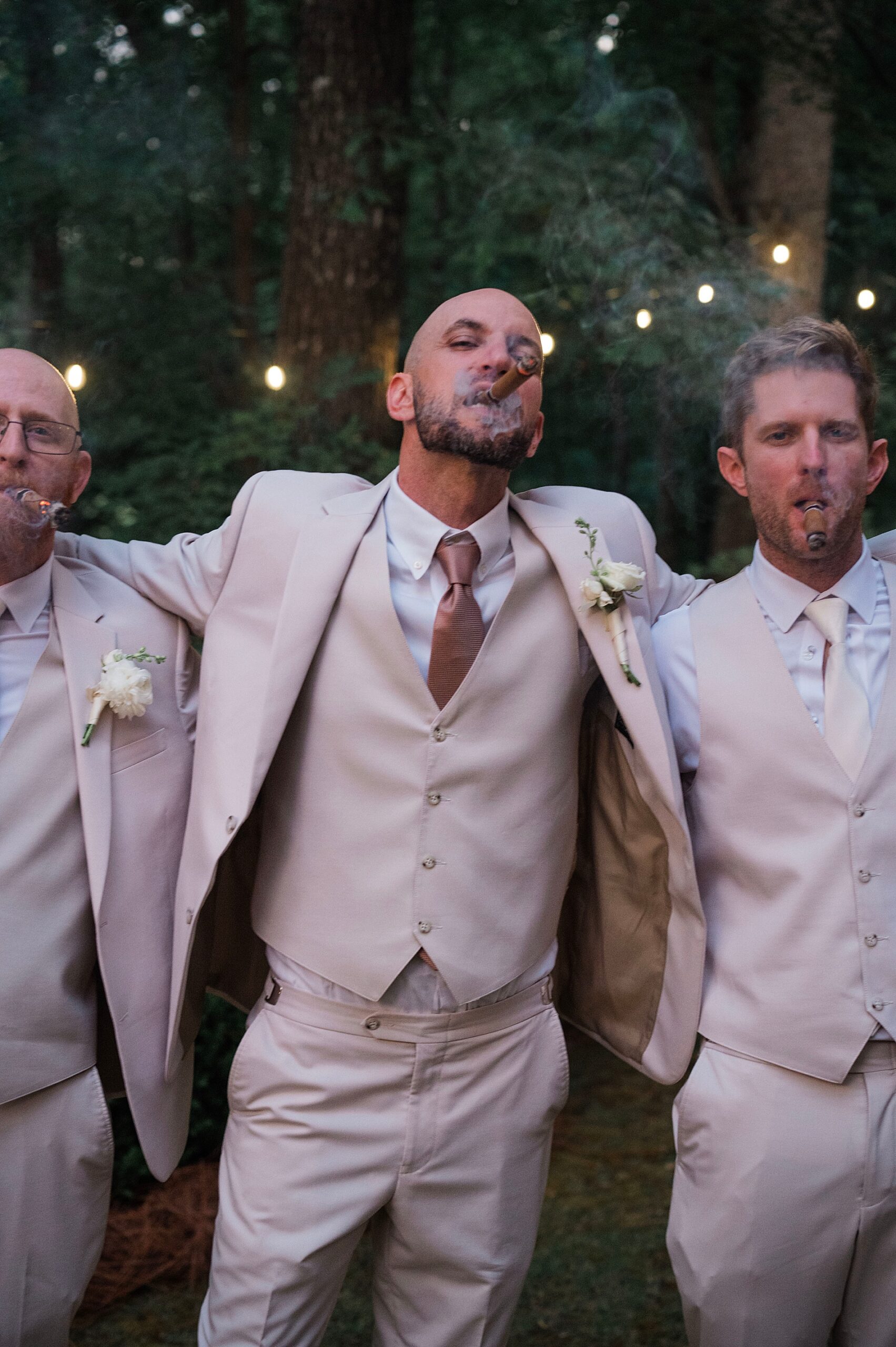 groom and groomsmen smoking cigars 