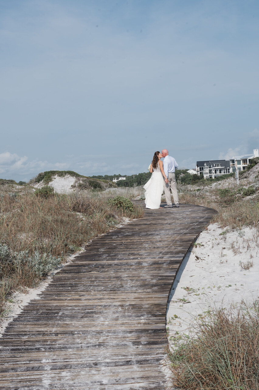 newlyweds kiss on the beach from 30A beach wedding weekend