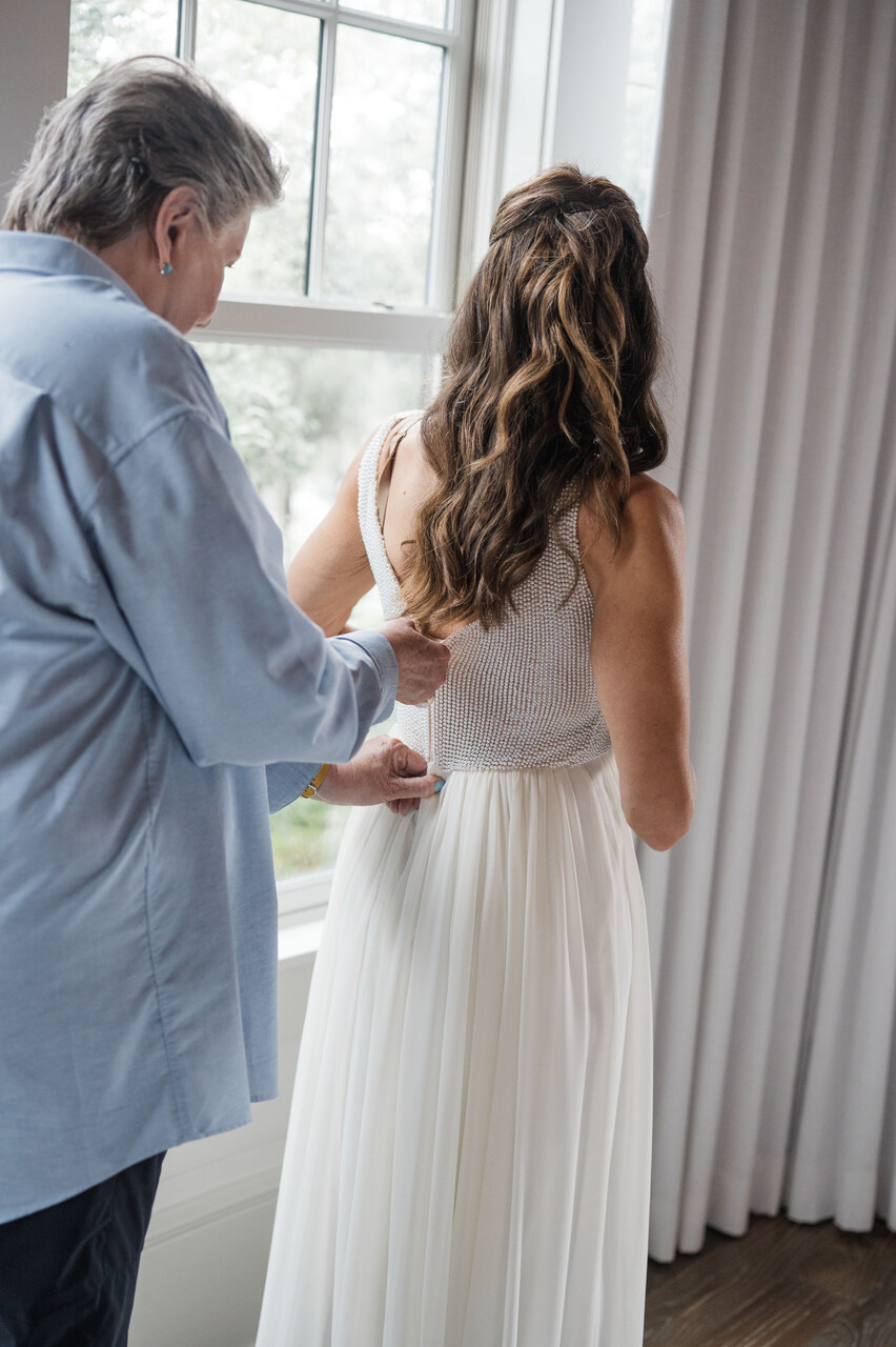 bride getting into wedding dress