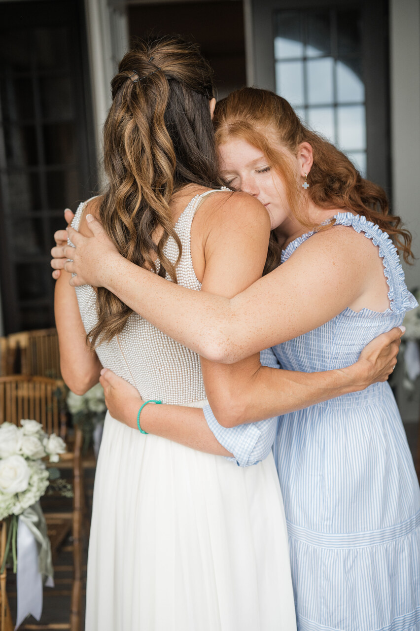 bride hugs daughter 