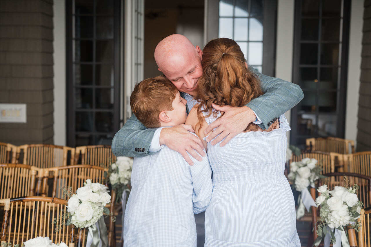 dad hugs two kids 